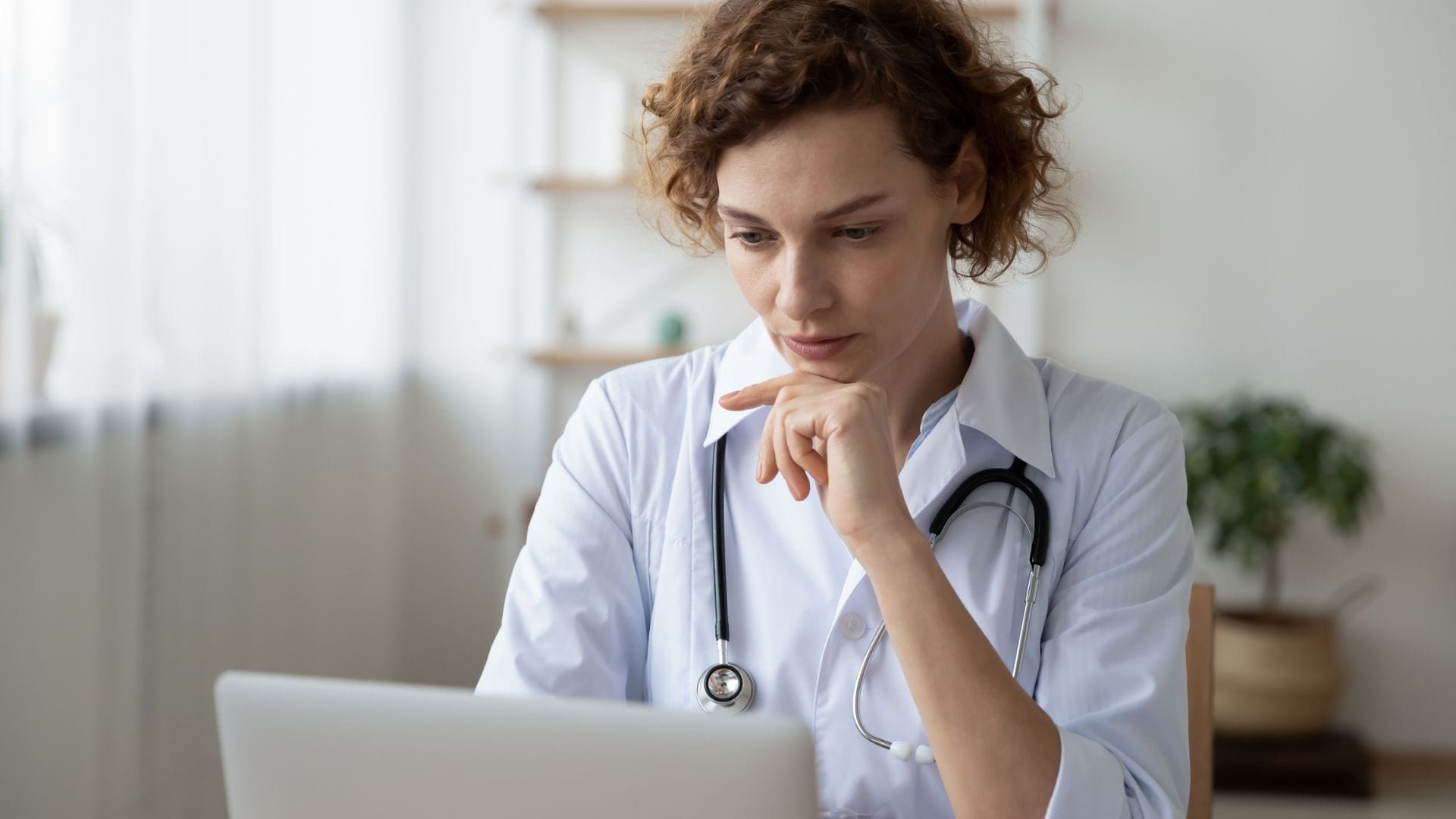 Female clinician working on computer