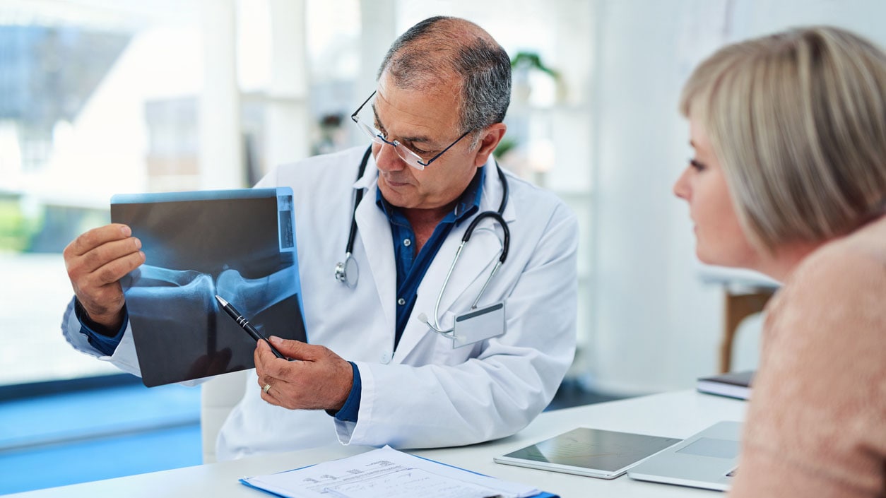 Doctor reviewing x-ray with his female patient