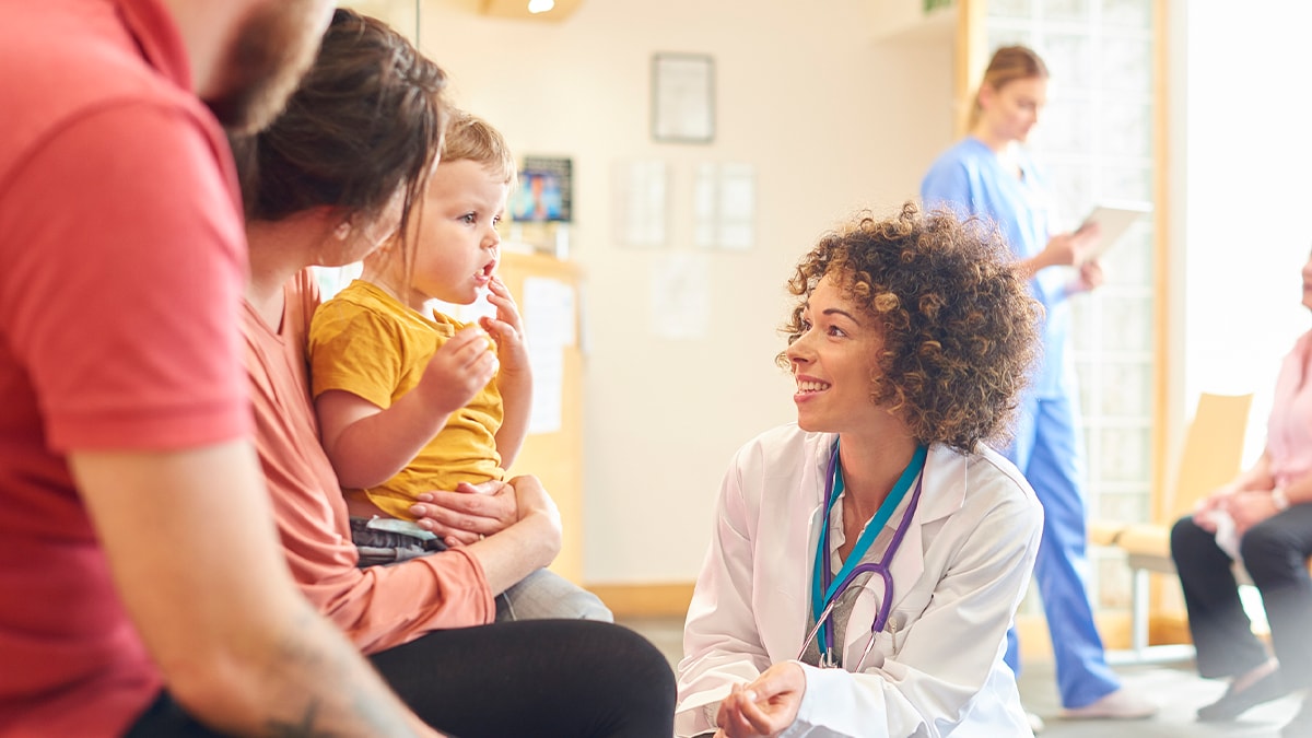 doctor meeting with family and their child