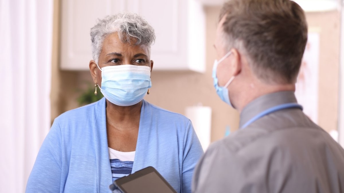 a nurse talking to a patient