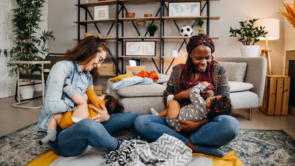 Two women breastfeeding infants