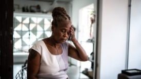 Older woman with hand on head appearing stressed