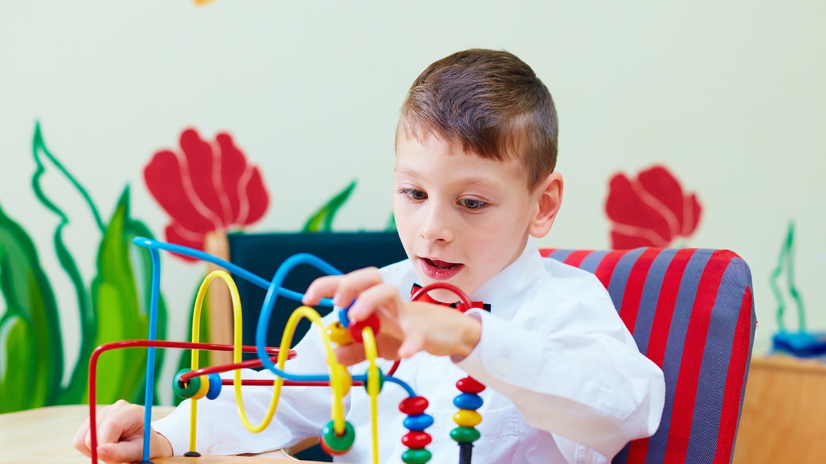 Child with cerebral palsy playing with a toy