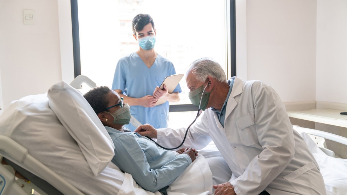 a cervical cancer patient in a hospital bed talking to her doctor