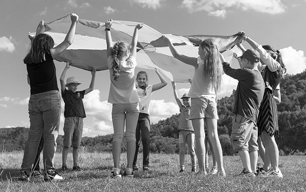 Children playing with a parachute.