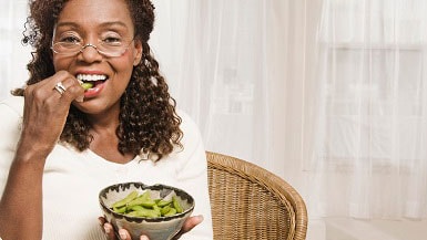 Woman eating edamame