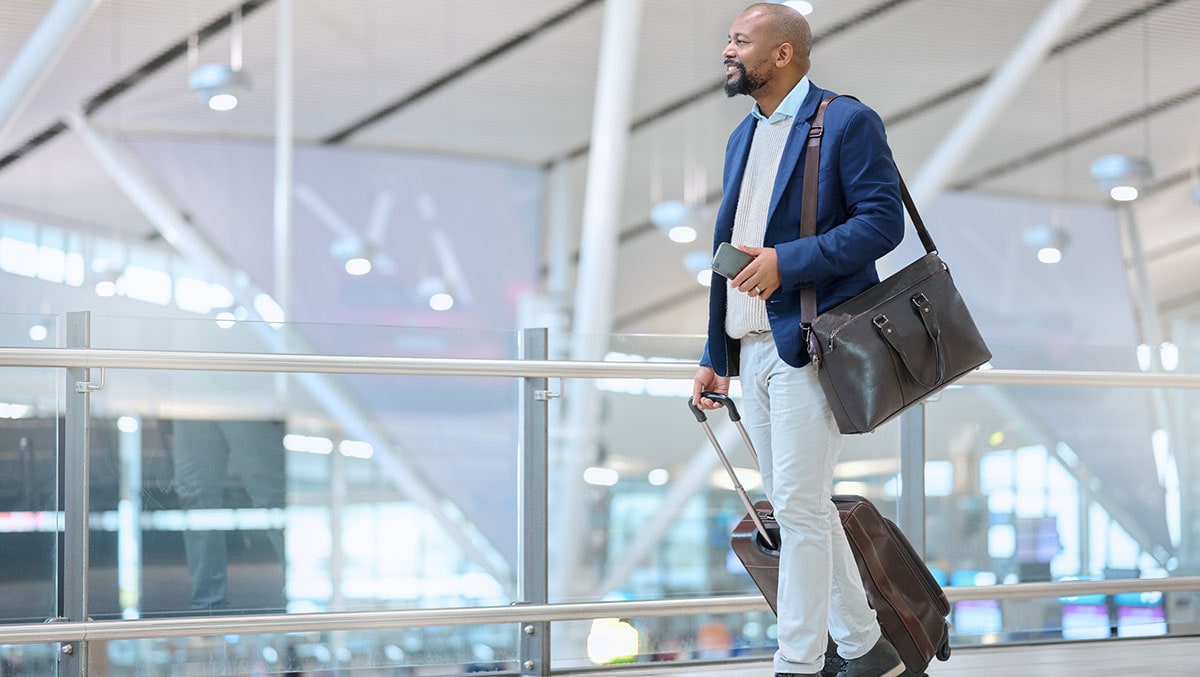 man waving goodbye at airport