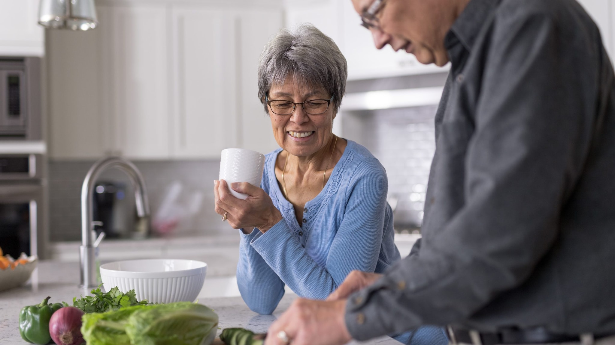 Older man and woman cooking together