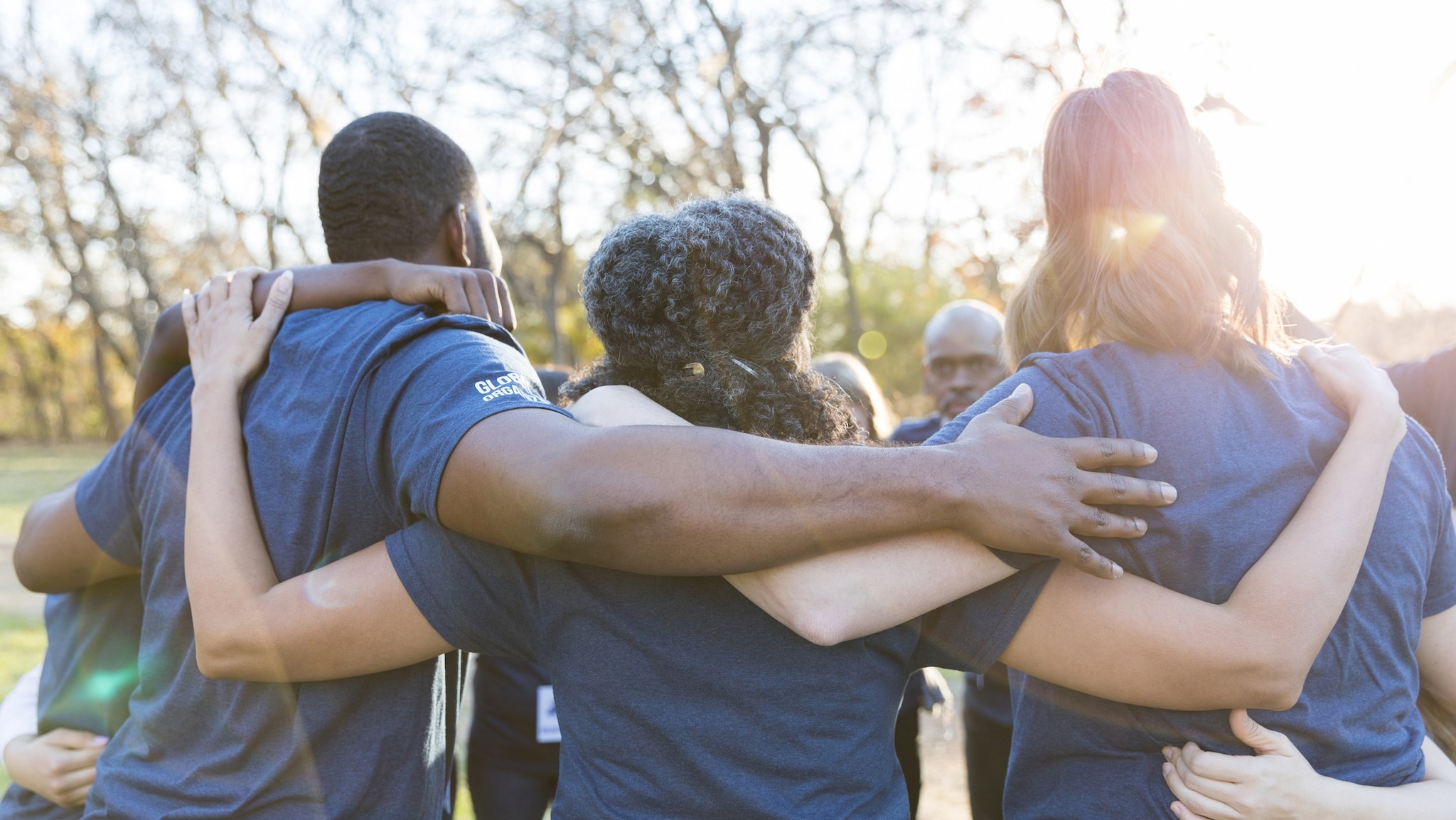 A group of volunteers embracing outside