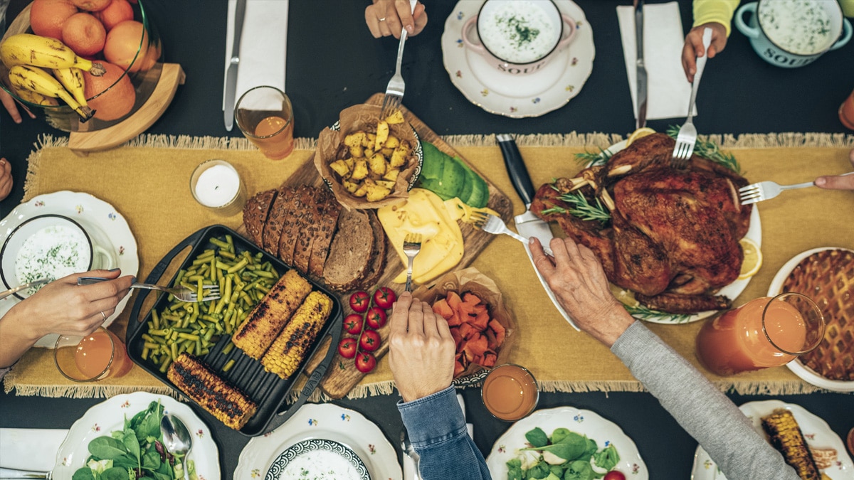 Dinner table with turkey, vegetables, and dinner plates