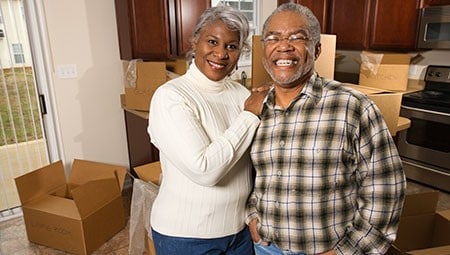 Older man and older woman smiling.