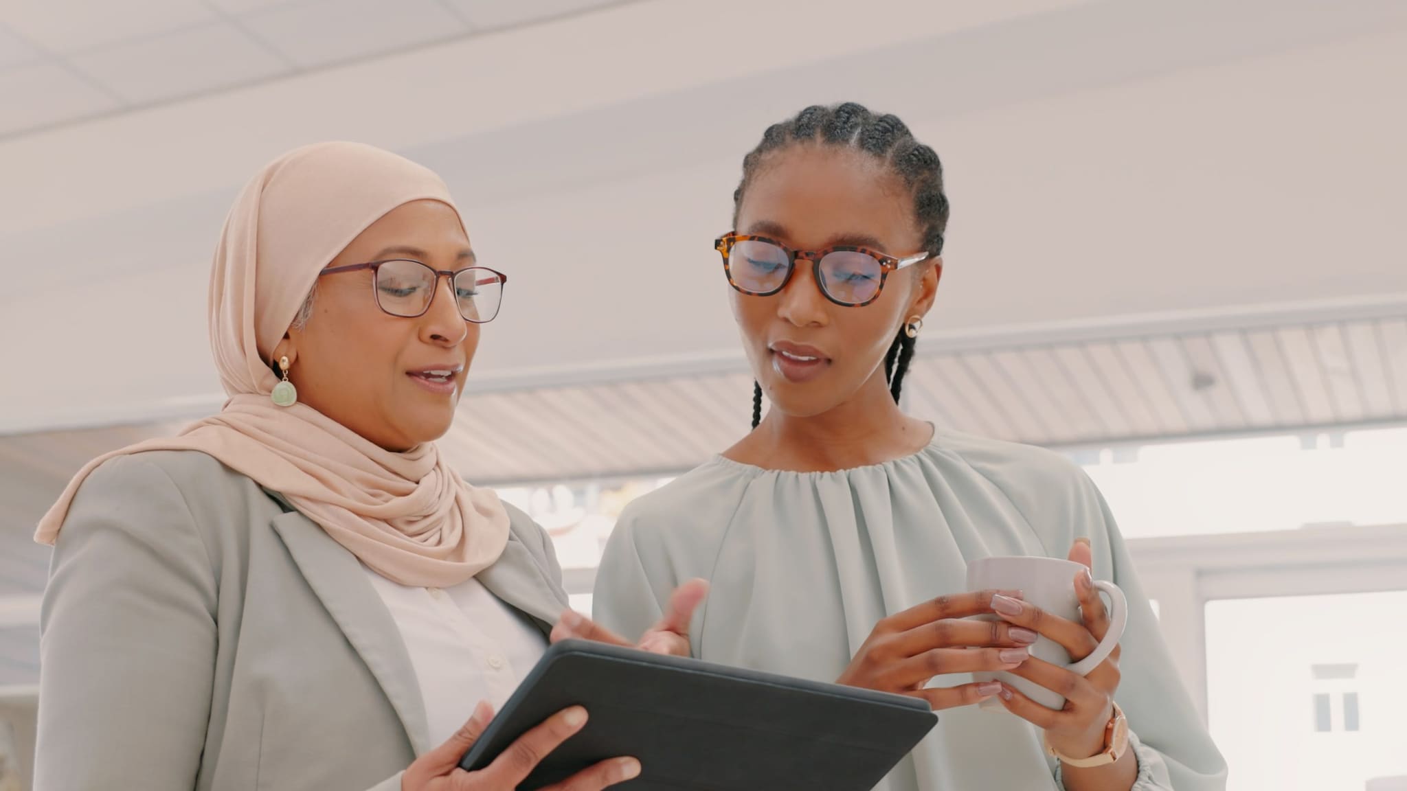 Two women looking at tablet.