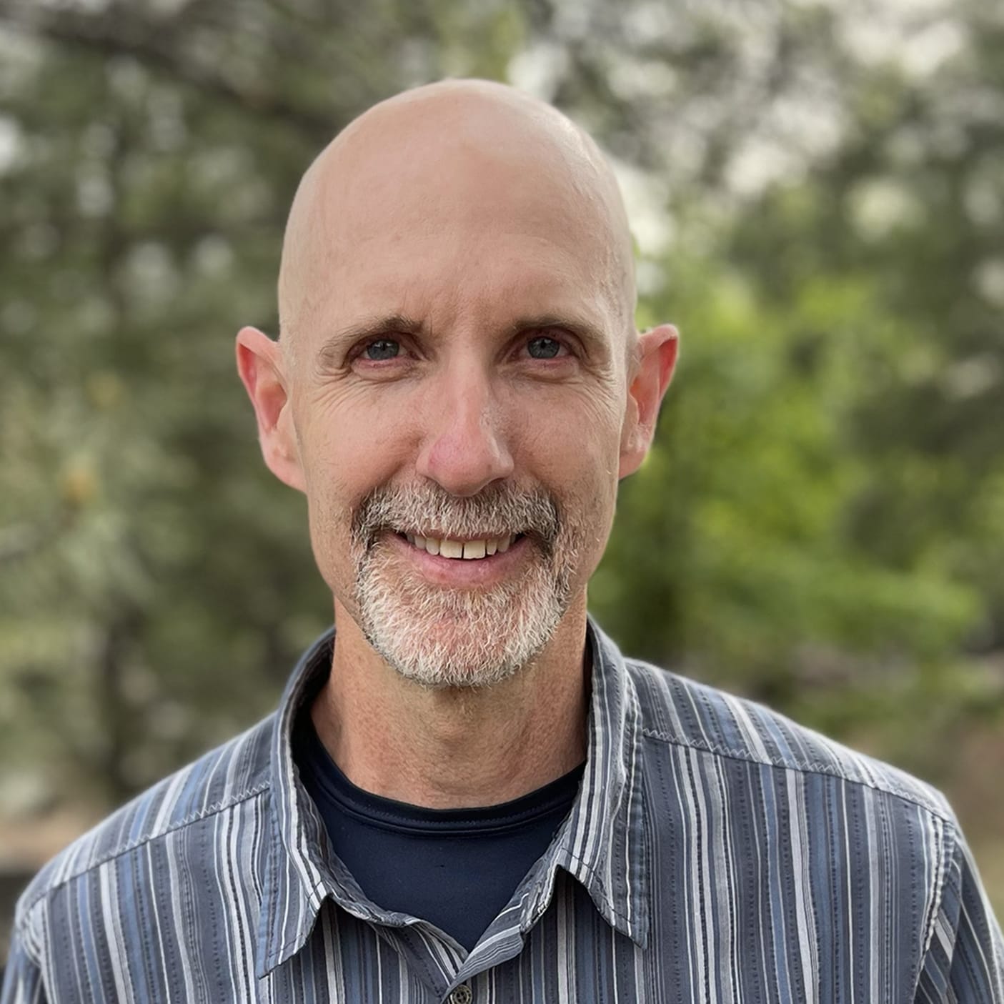 Eric Rescorla wears a blue and white striped button down with a black undershirt