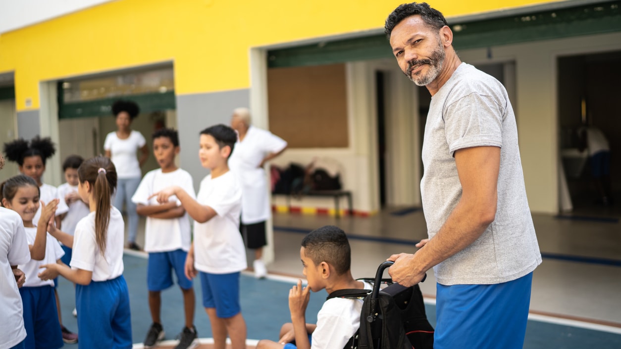 teacher helping a student in a wheelchair