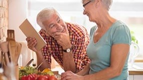 Couple preparing food in kitchen.