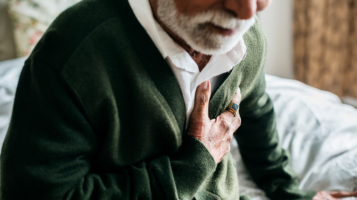 A man clutching his chest