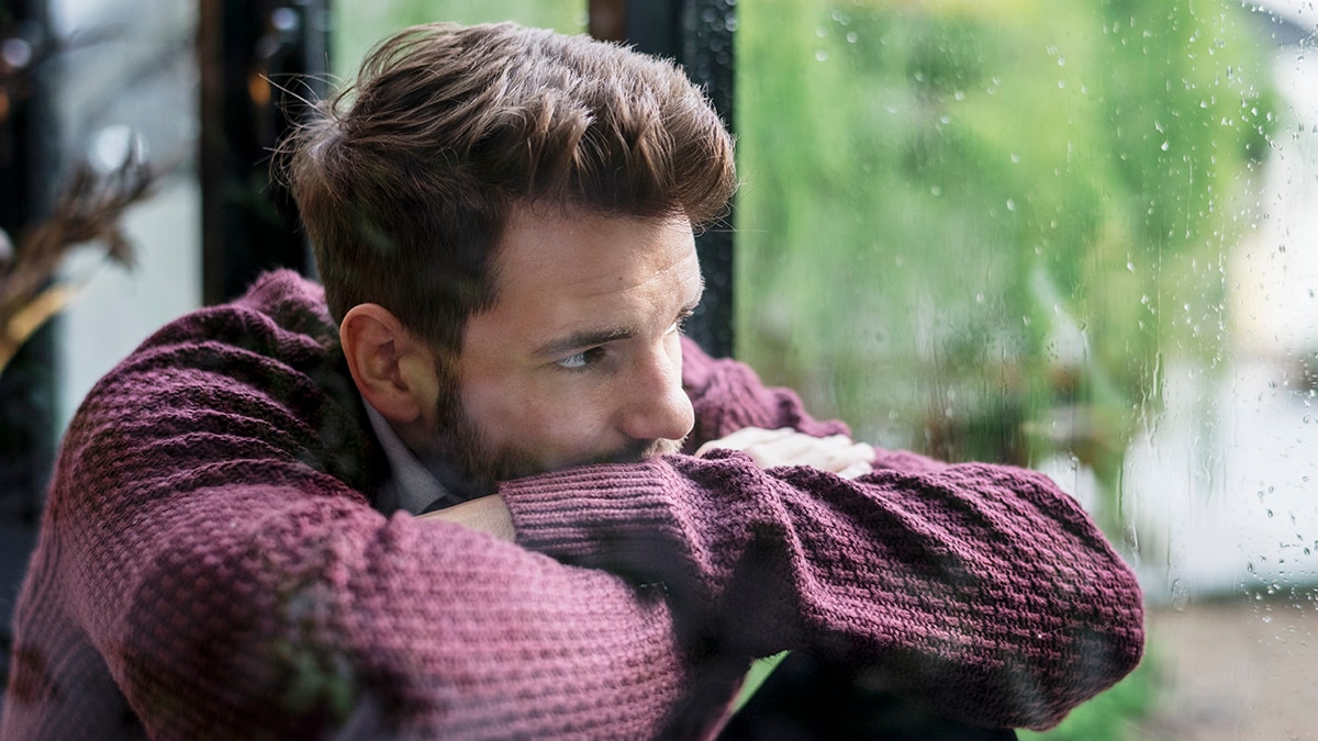 Thoughtful man looking out the window