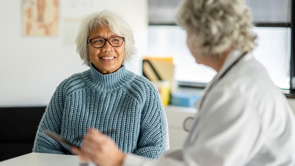 A healthcare professional  meets with a patient to discuss hepatitis a and b testing and vaccination resources