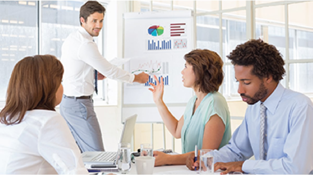 Group of people looking at a chart.