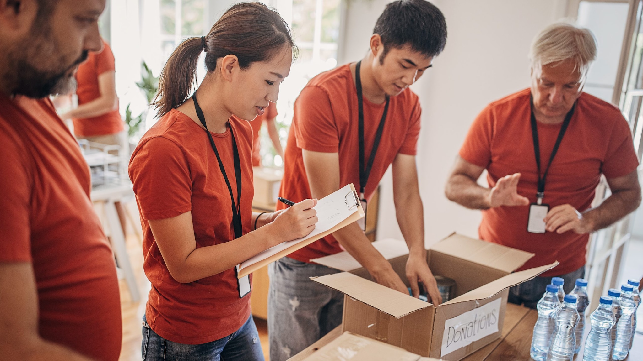 Relief workers helping with donations in a shelter.