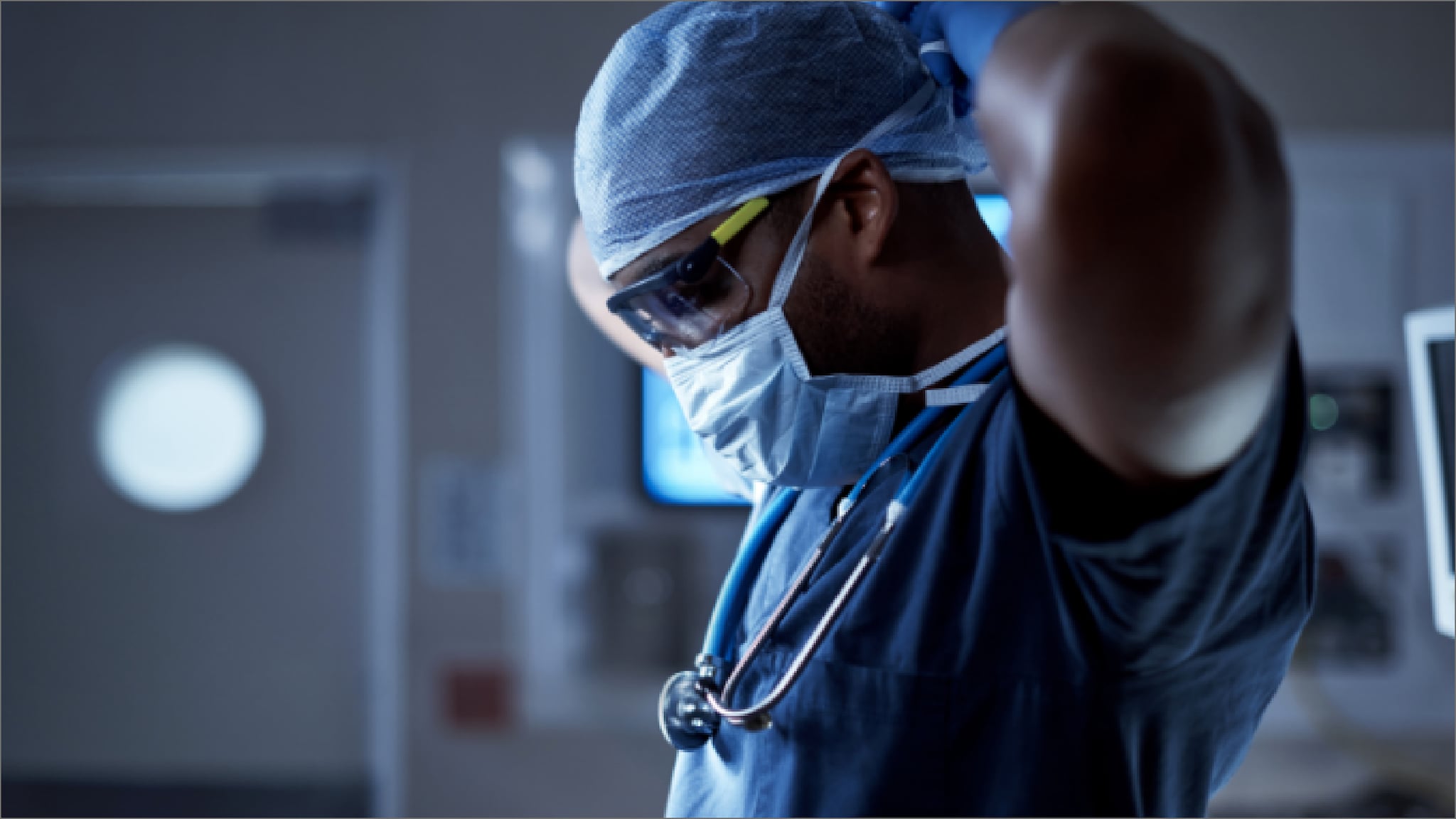 Physician Putting on personal protective equipment in a healthcare setting