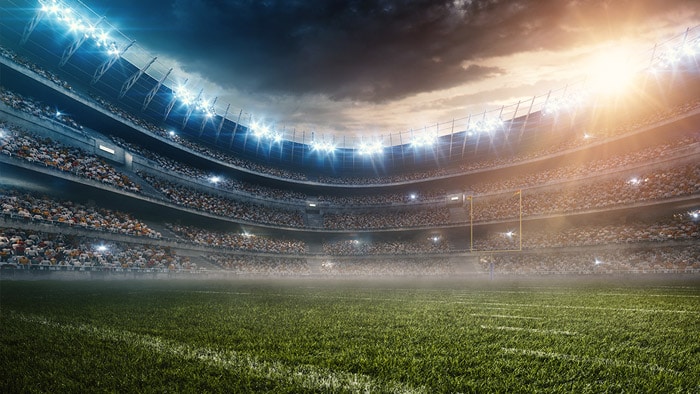 Outdoor stadium with stormy clouds looming overhead.