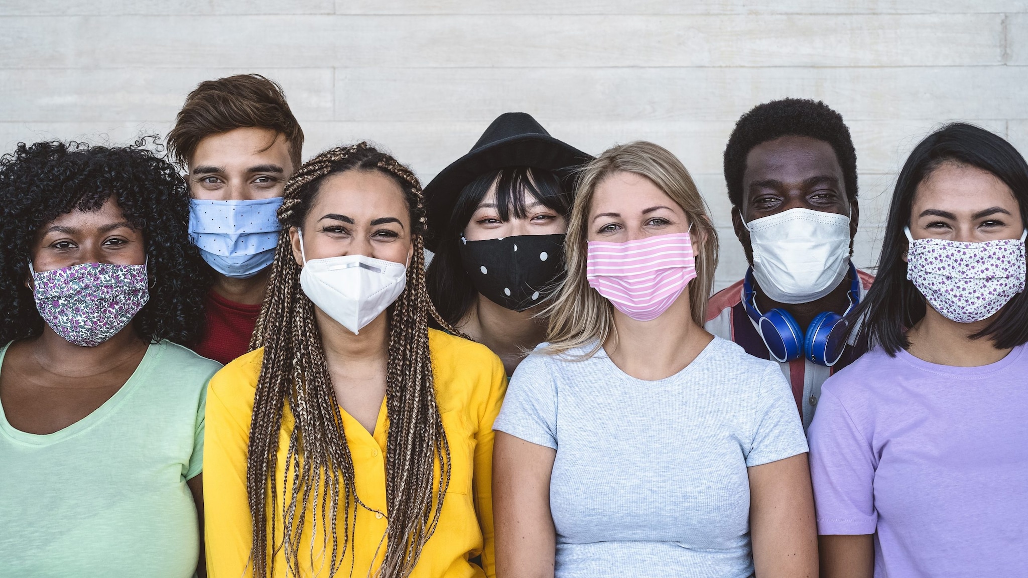 A diverse group of people wearing masks.