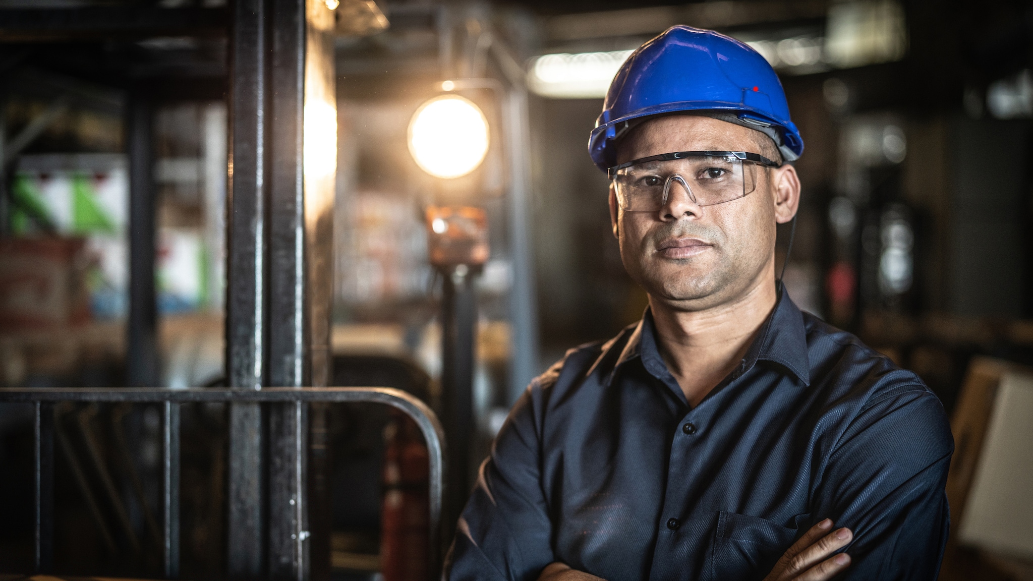 Close up image of a worker wearing PPE in an industrial setting.