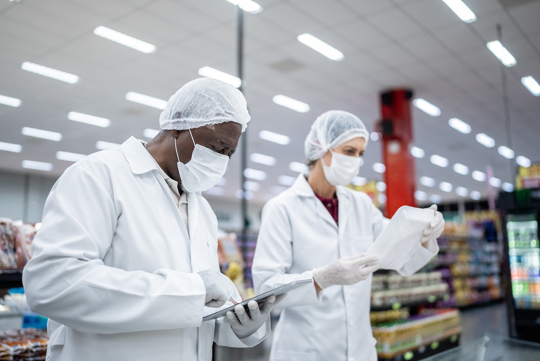 Food safety inspectors examining food from gorcery store.