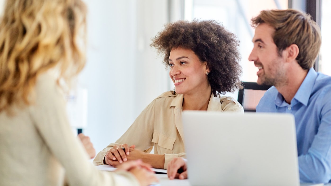 Young professionals around a computer