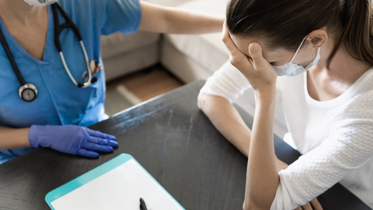 Photo of a patient discussing their symptoms with their healthcare provider.