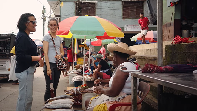 Two staff members chatting with residents of Guapi.