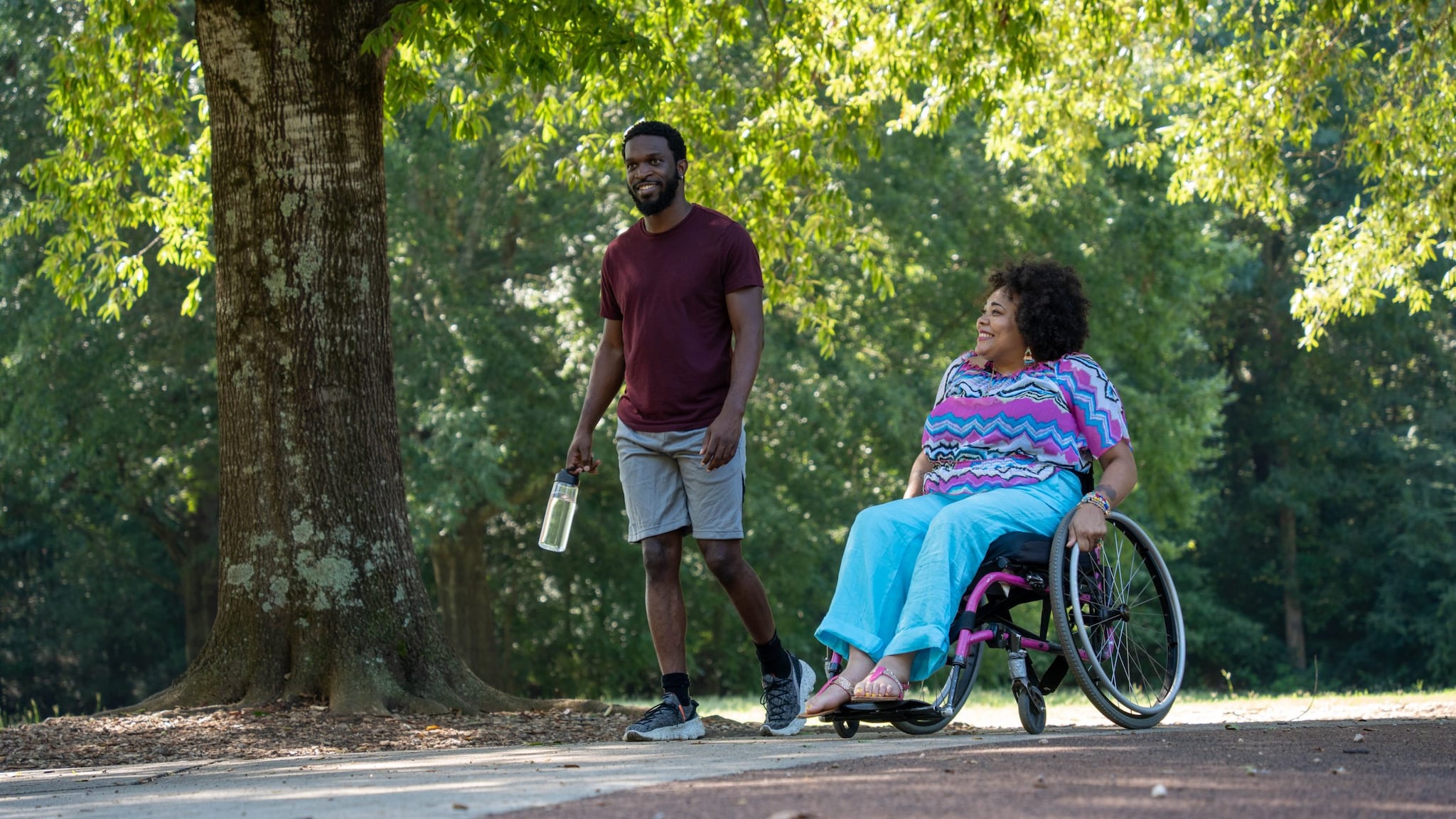 Friends walking and rolling in the park.