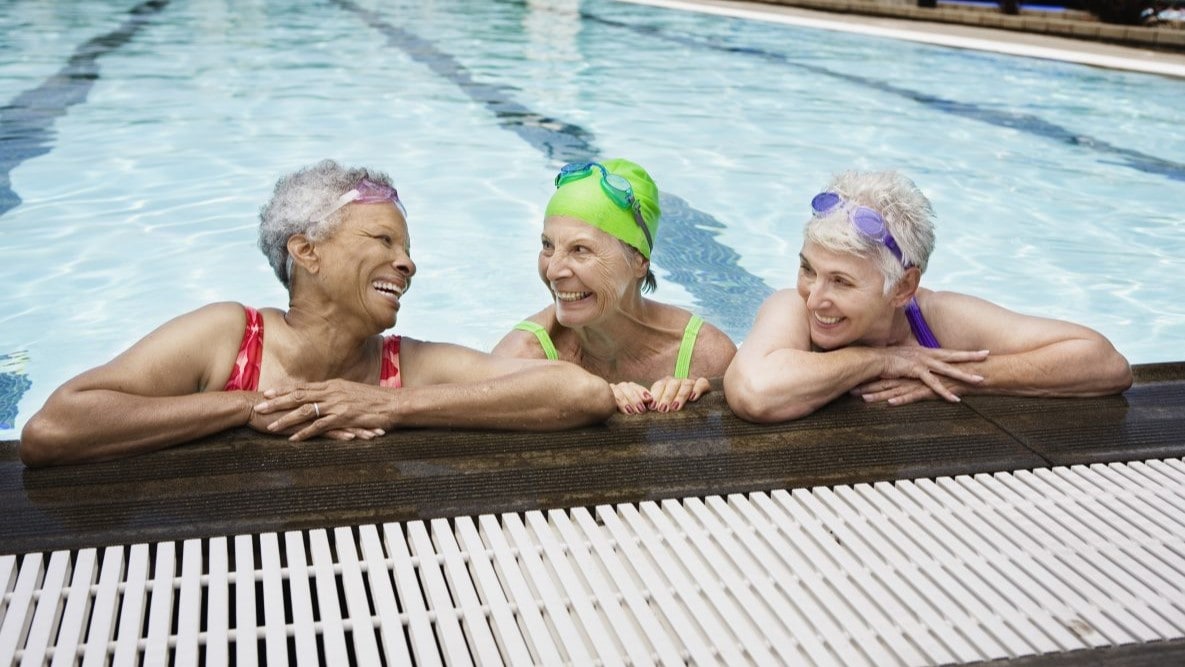 Three older women in a pool.