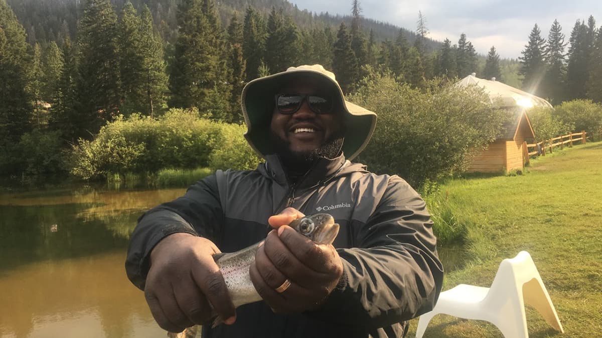 Dariun wearing sun protection gear while fishing.