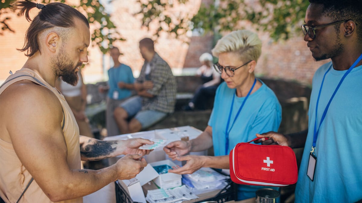 Workers provide food and aid at a syringe services program (SSP) site.