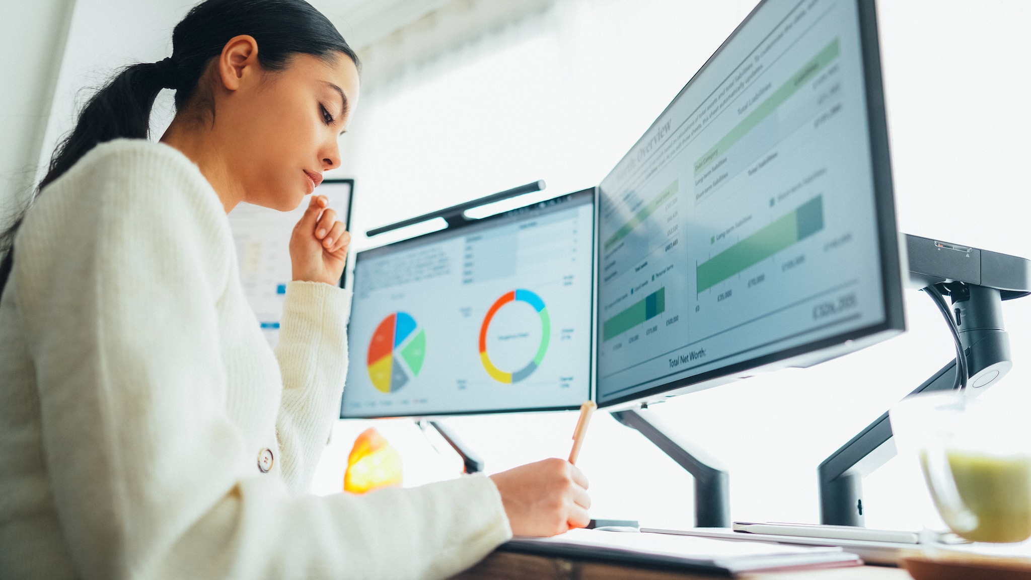 Female epidemiologist working on data analysis on computer.