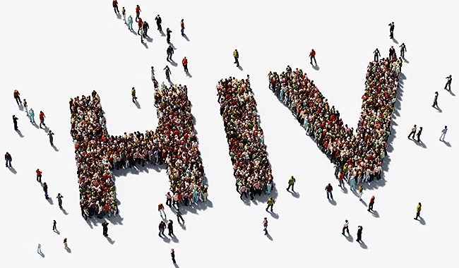 Large crowd of people arranged so they spell out HIV.