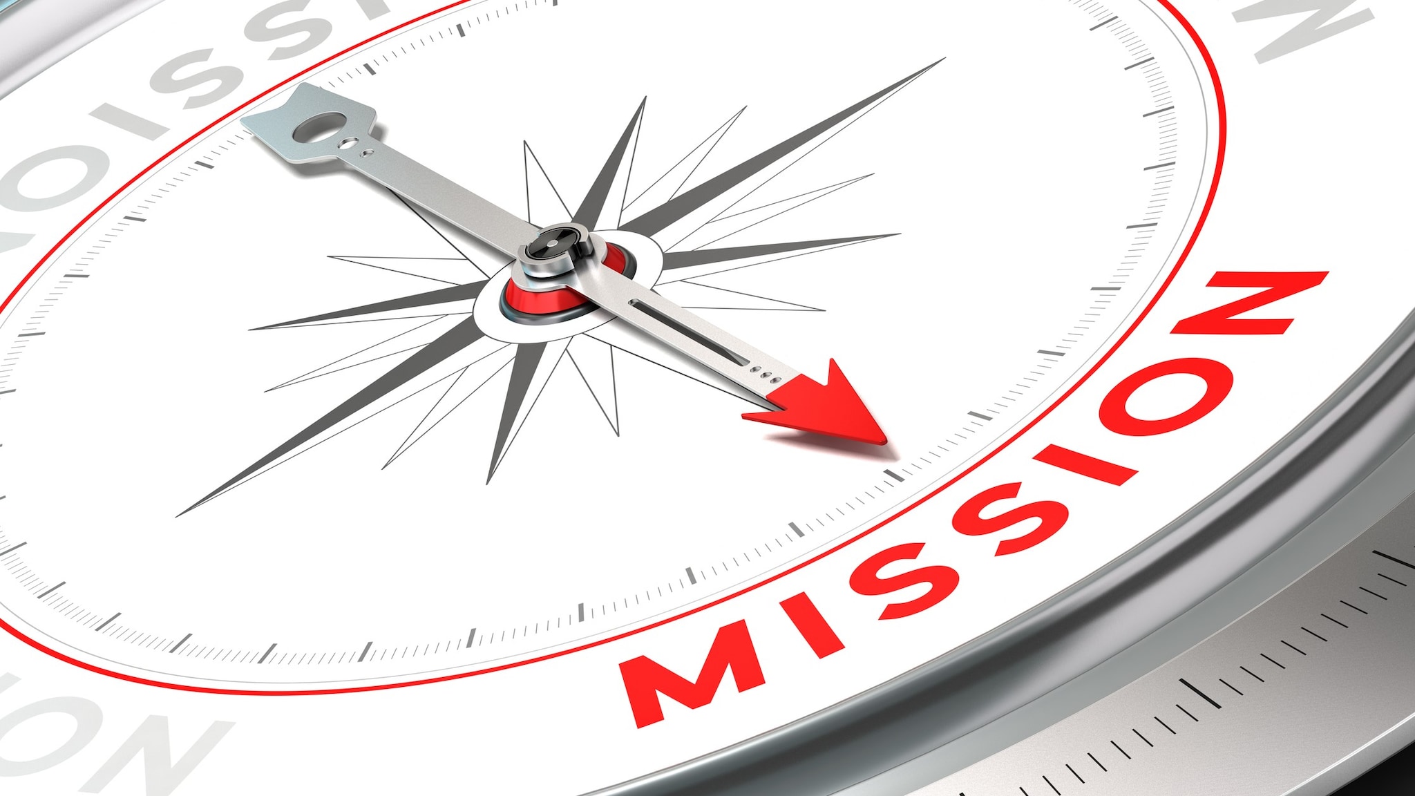 Closeup photo of a compass with the arrow pointing to the word "Mission."