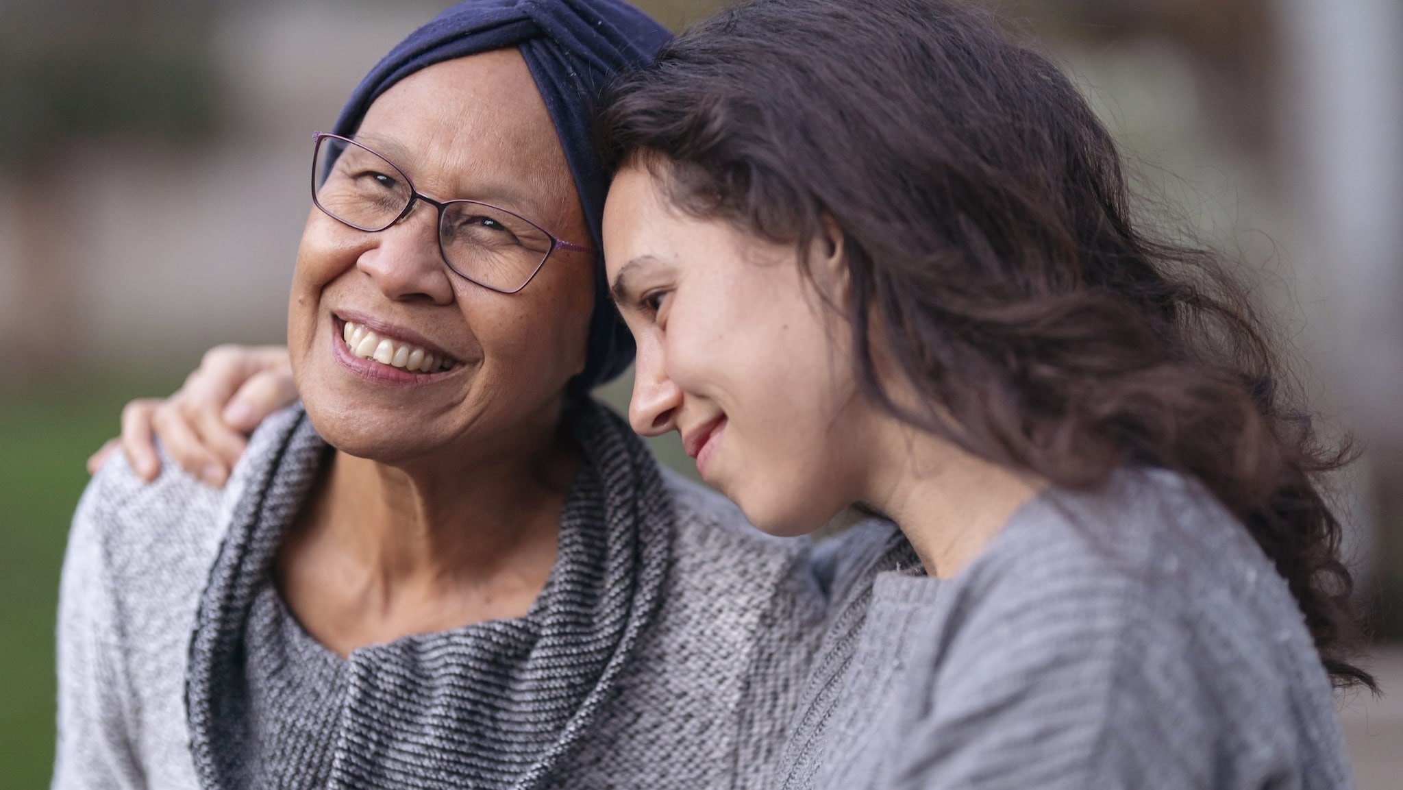 An older adult mom and her daughter embrace